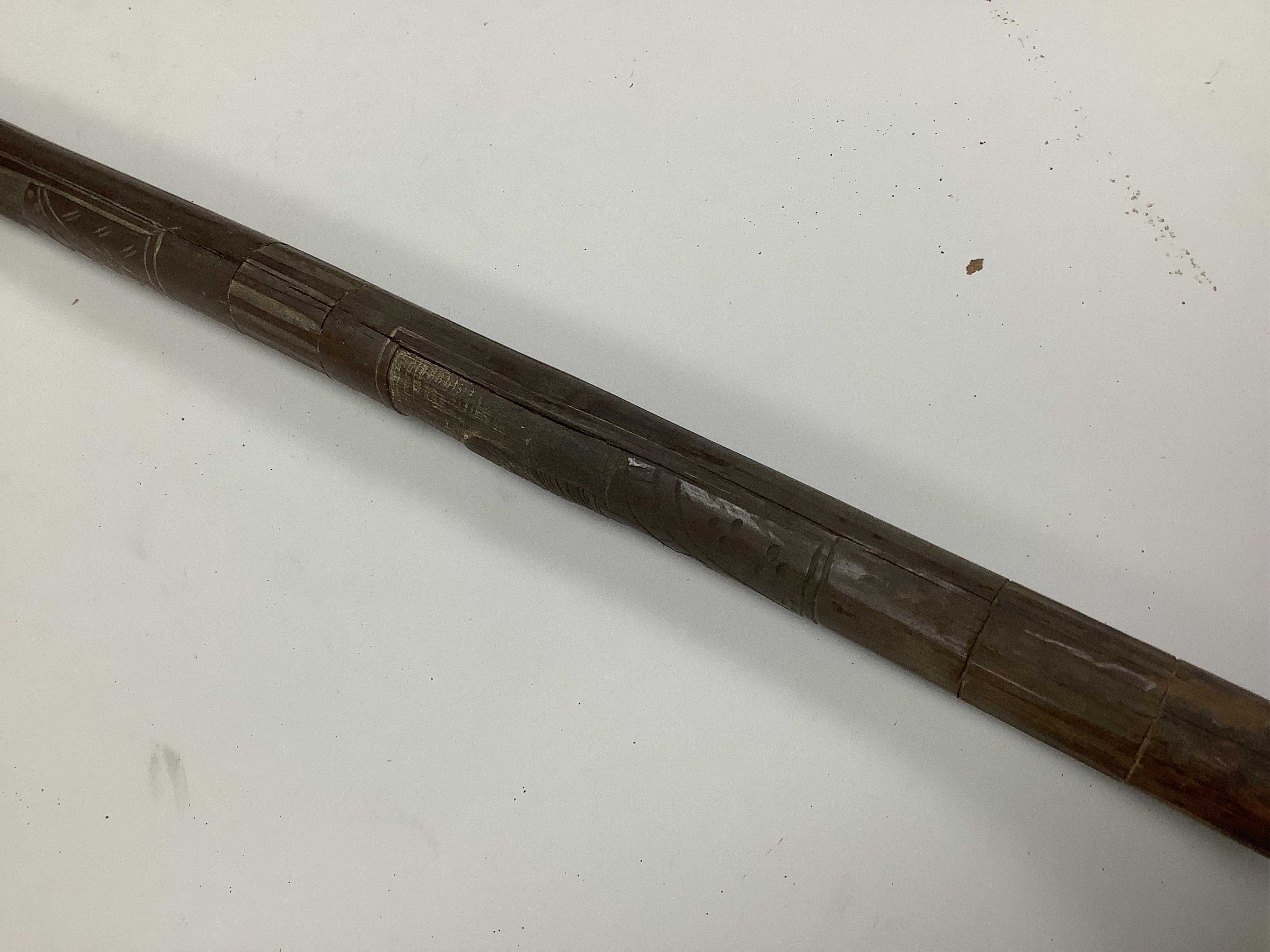 An officer’s sword, three walking sticks and an antique sword stick, longest walking stick 92cm long